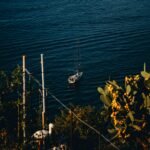 A small boat floating on top of a body of water