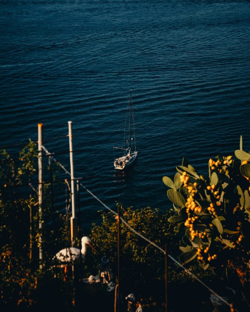 A small boat floating on top of a body of water